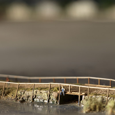 Man on bridge fishing in the Mystic River