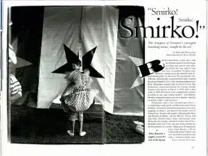 A child in a polka dot outfit stands performing in front of a star-patterned background. The text "Smirko!" is prominently displayed, along with an article discussing a circus performer.
