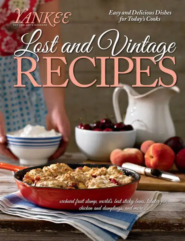 Cover of Yankee magazine titled "Lost and Vintage Recipes" featuring a baking dish with a crumble dessert, fresh cherries, and peaches. Subheading mentions dishes like orchard fruit slump and lobster pie.