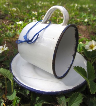 Enamelware cup and saucer turned into bird feeder 