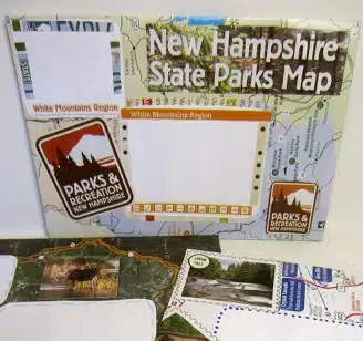 A New Hampshire State Parks map focused on the White Mountains Region, featuring illustrations and photos of scenic areas, wildlife, and parks and recreation information.