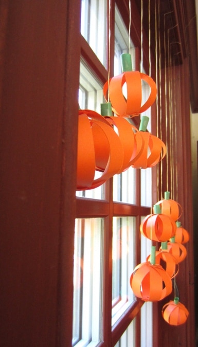 Paper Pumpkin Orbs hanging in the window