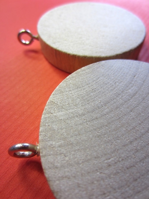 Eye hook screws attached to wooden circles