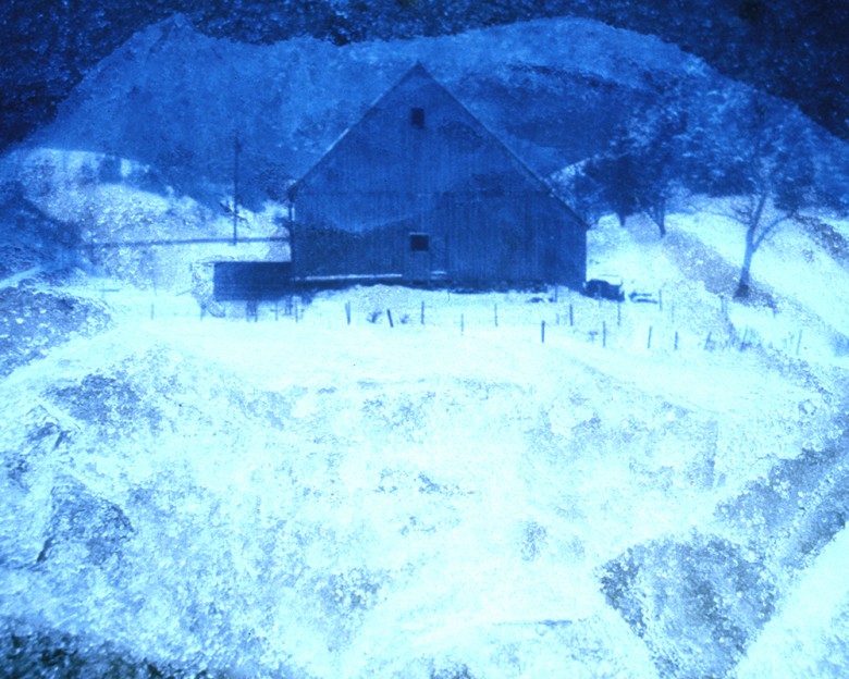 Double-exposed barn. snow on plastic.