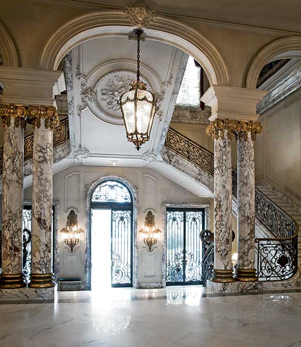 The grand entrance foyer, with its Ionic columns of Italian breccia marble. 