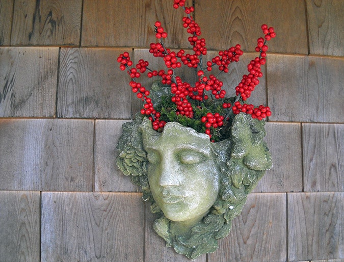 Fill a planter with festive stems of winterberry.