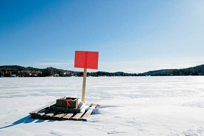 Atop the chilly expanse of Joe’s Pond in West Danville, Vermont, a pallet awaits the moment when the ice starts breaking up, heralding the much-anticipated spring thaw. 