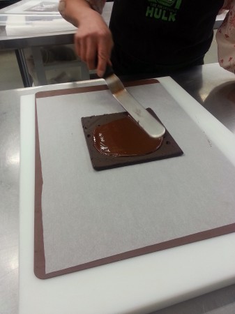 Coating the top of the ganache, which will become the bottom of the bonbon.