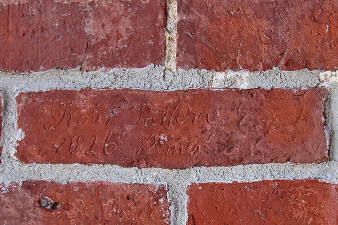 What's so special about this brick? It's signed by Robert Patten, the Master Mason who built the building Amesbury Industrial now occupies. Masons traditionally scratched their names into a brick laid on the East side of a building.