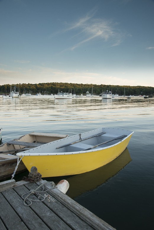 A yellow dinghy awaits dockside in Round Pond, Maine.