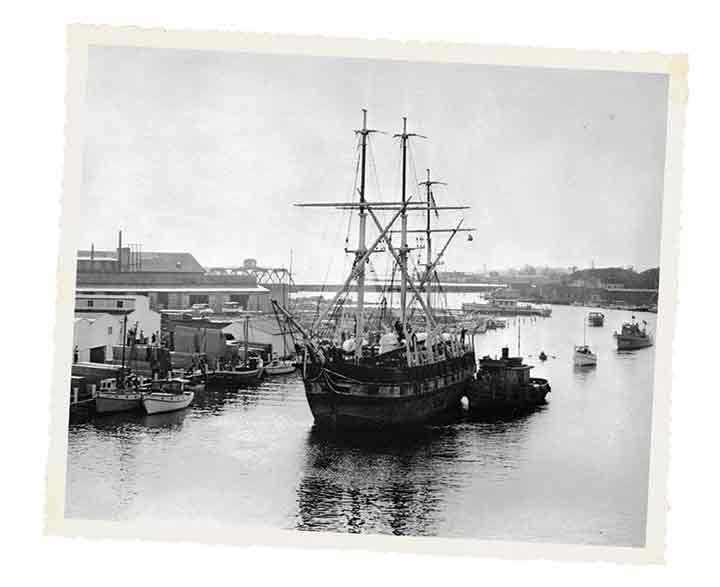 A tug pushes the whaler Charles W. Morgan up the Mystic River on the final leg of its journey from New Bedford, its home port, in 1941.