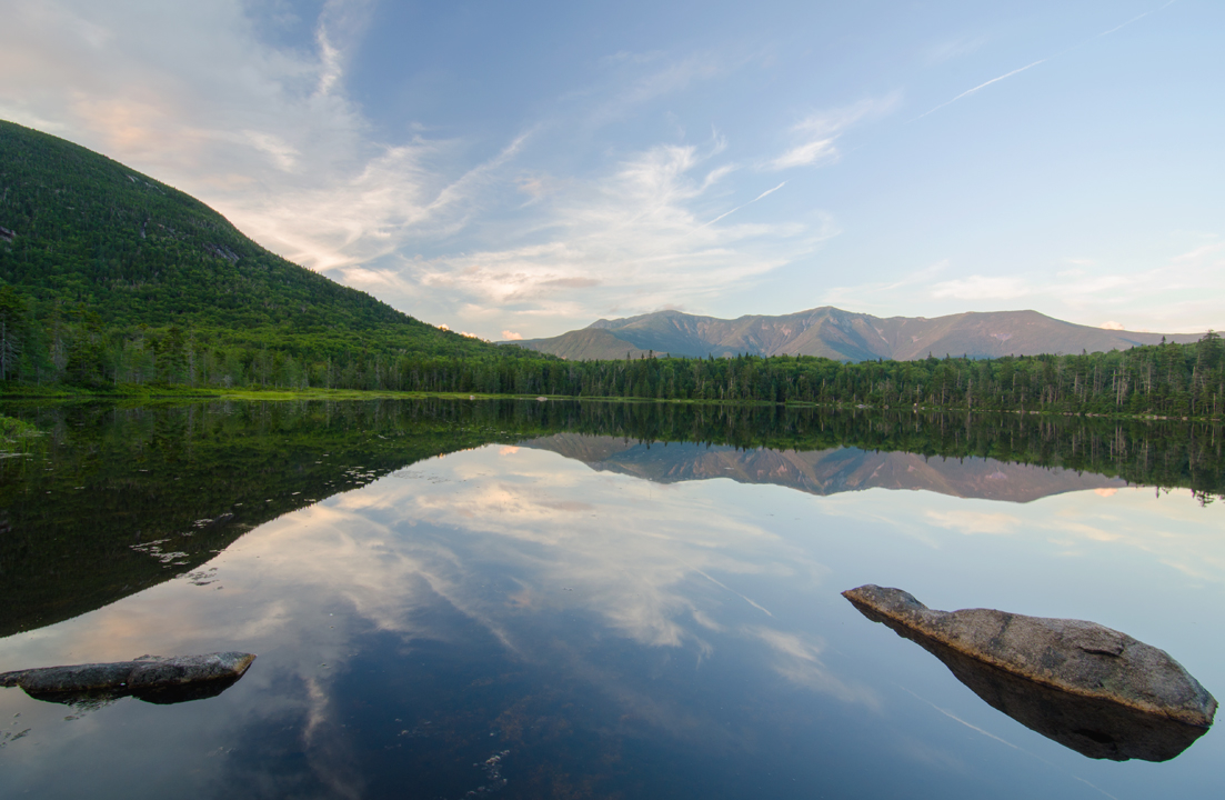 The calm water of Lonesome Lake reflects Franconia Ridge near perfectly on an early summers eve.