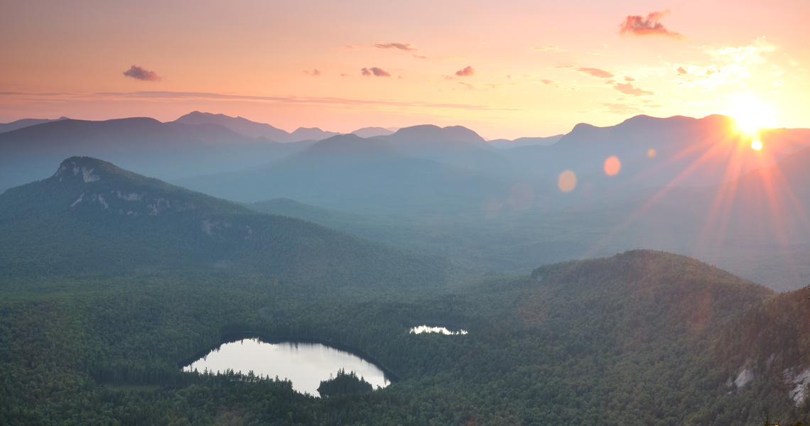 The setting sun and Sawyer Pond in New Hampshire's White Mountains.