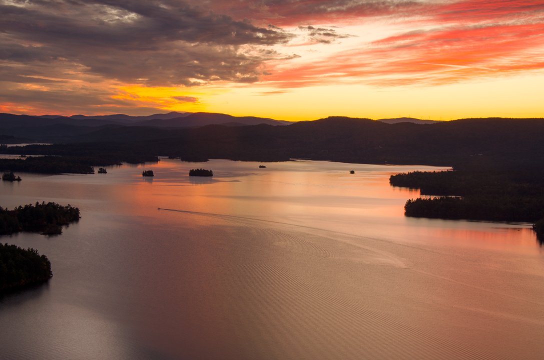 Sunset's fiery glow relects in Squam Lake.