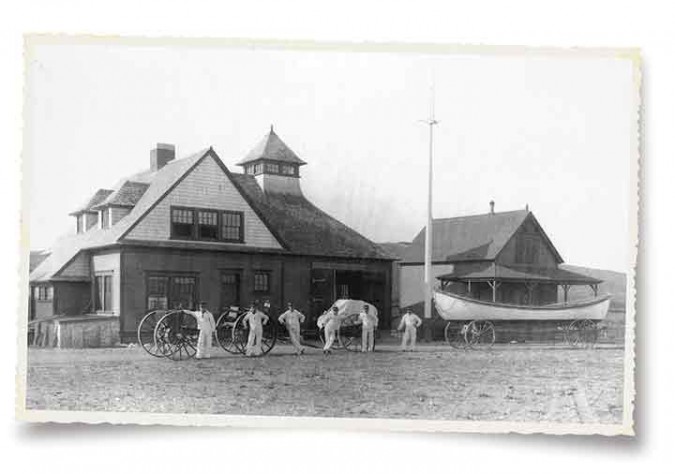 “Storm Warriors” at Point Allerton U.S. Lifesaving Station, Hull, Mass., c. 1891. Today this headquarters is home to the Hull Lifesaving Museum, featuring photo and artifact collections and hands-on exhibits on the maritime history of Boston Harbor. At right is a rescue surfboat atop a beach cart, ready to roll.