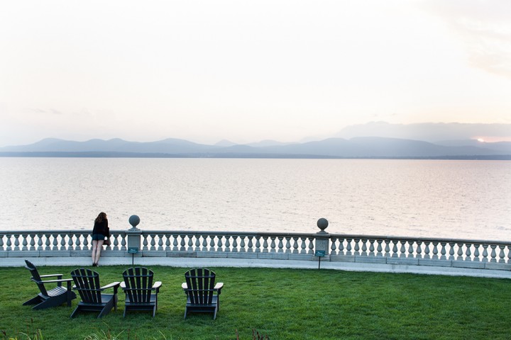 A guest overlooks the view of the Adirondacks in New York State from the Inn at Shelburne Farm's expansive lawn.