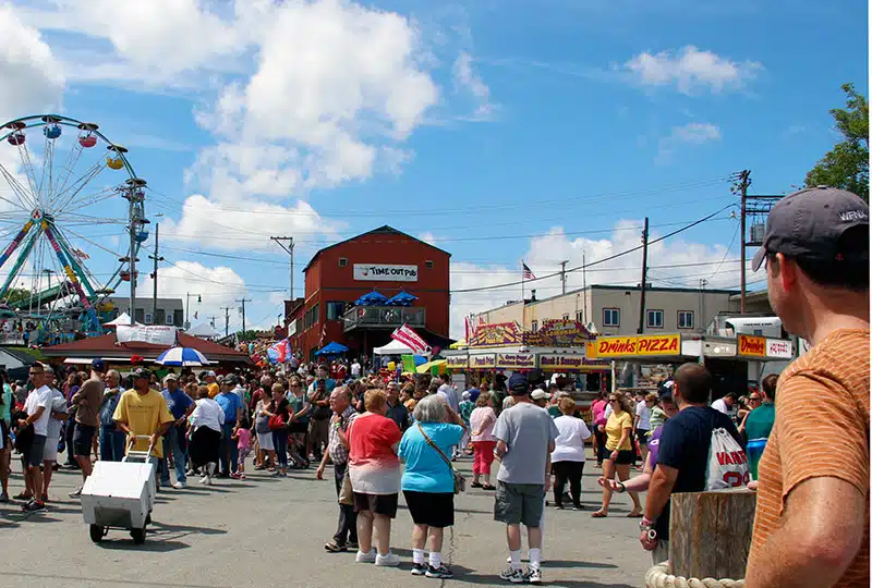 Crowds of people mill around the grounds.