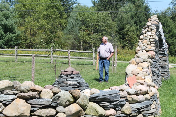 a visitor takes in the stone spectacles at Thea Alvin's sculpture garden