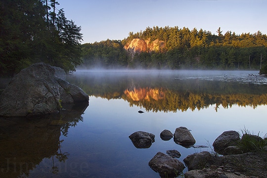 An Early Sign of Autumn, Mist Rises Above a New Hampshire Pond in August