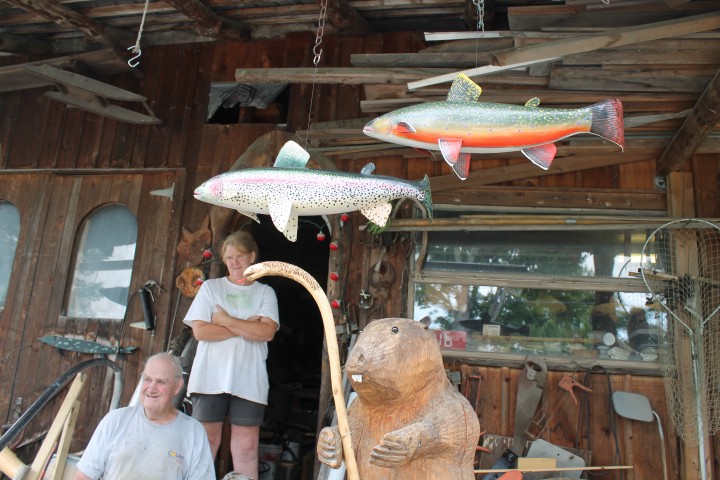 Sonny Sweat and his daughter Rhoda Sweatt on the porch of their Craftsbury, VT workshop amid their creations