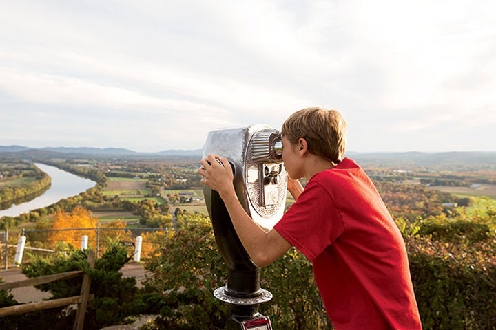 A visitor finds a sweet view of the Connecticut River from Mount Sugarloaf in South Deerfield.