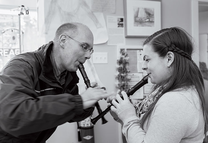 Benson plays the recorder with Emma VanDyne at the Matinicus School. 
