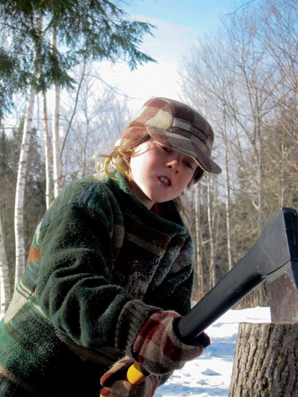 Rye splits a log for fire­wood; “Apple” is in the lead as Rye brings some of the herd in.