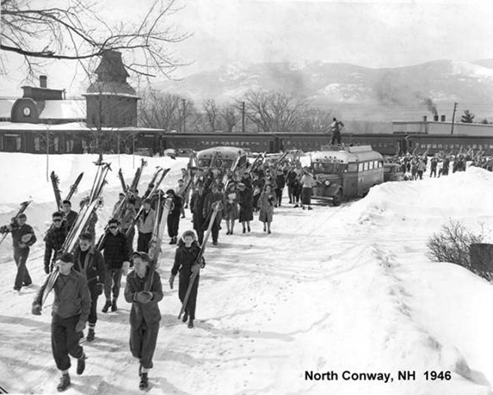 Skiers disembark from buses at the train station in North Conway, New Hampshire, circa 1946.