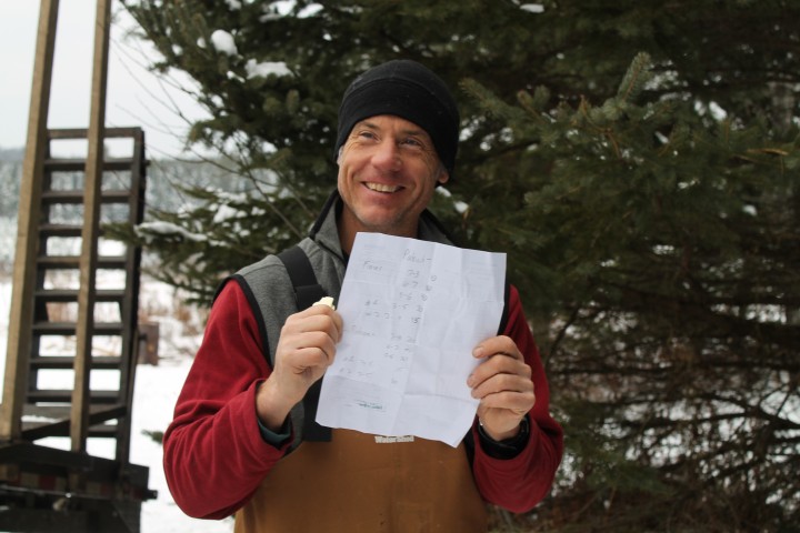 Christmas Tree Farmer Steve Moffatt  with the list of what they're about to load 