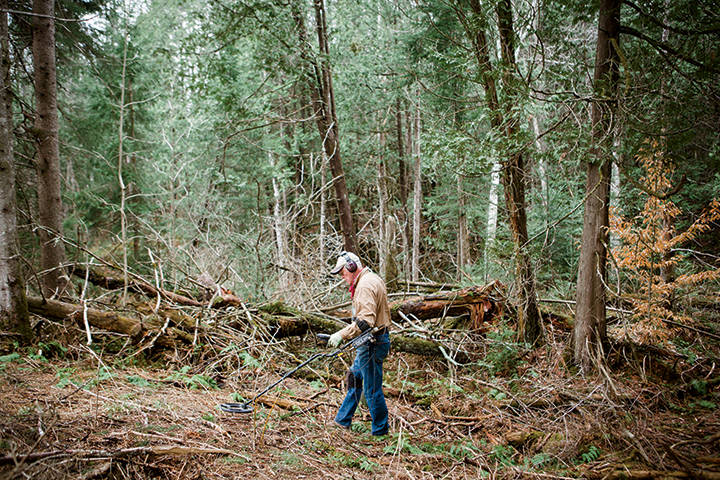 Dave Linck searches a wooded area in Vermont’s Caledonia County. 