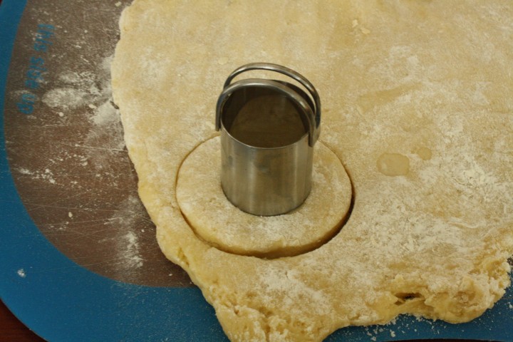 Two biscuit cutters do a good job of cutting the dough if you don't have a donut cutter.