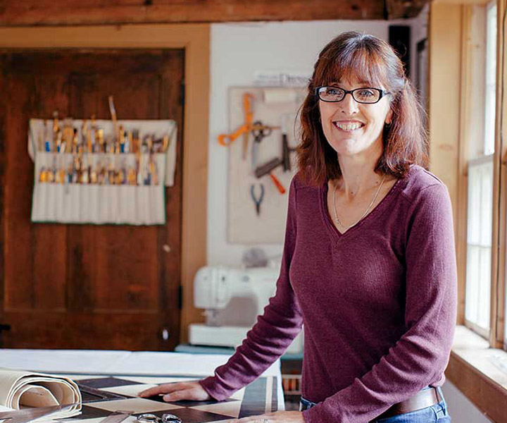 Lisa Curry Mair, shown here in her studio in Perkinsville, Vermont, has painted more than 1,000 floorcloths during the two decades she has devoted to her craft.