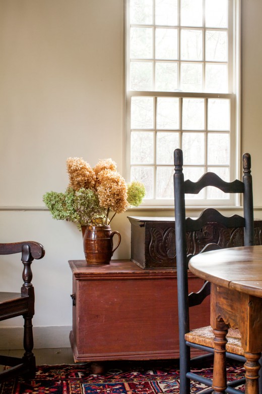 Antique furnishings and restored original walls lend a gracious tone to the dining room