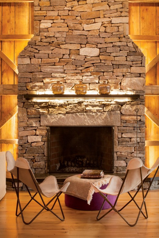 A massive stone fireplace makes for a dramatic centerpiece along one wall.
