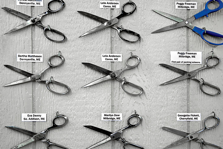 Each pair of scissors, with a woman’s name and hometown, represents a lifetime of 12-hour workdays.
