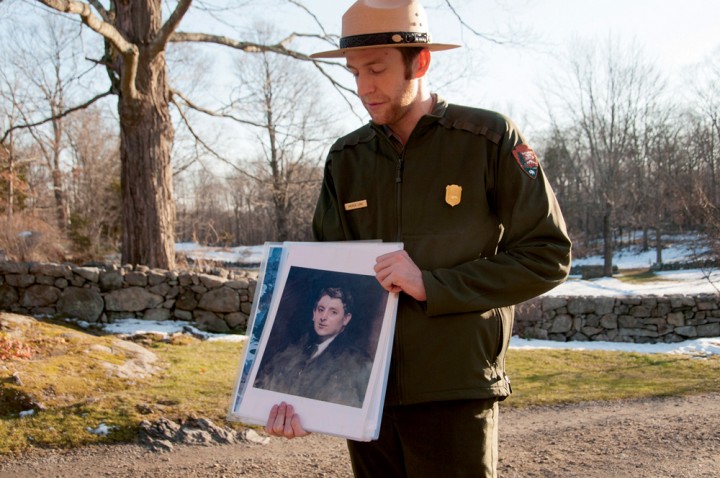 At Weir Farm, ranger Andrew Lowe holds an image of a portrait of Impressionist painter J. Alden Weir by John Singer Sargent.