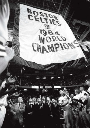 Celtics general manager Red Auerbach and forward Larry Bird raise the 1984 basketball championship banner at Boston Garden.