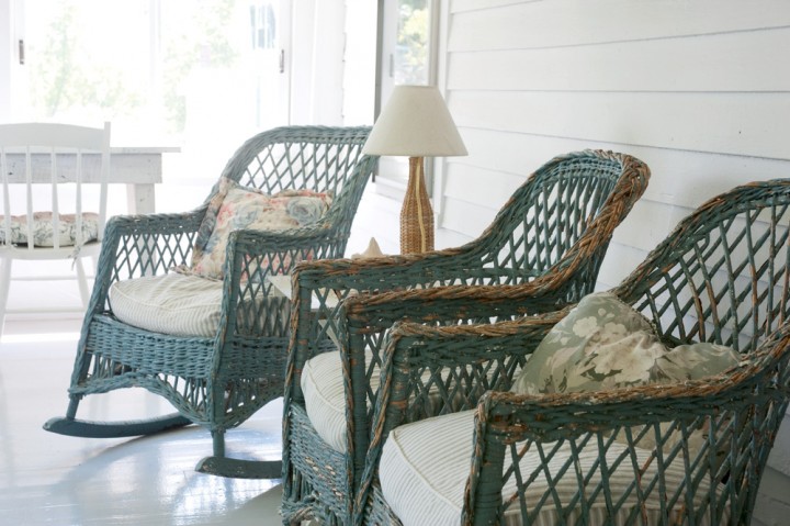 Looking out toward the nearby barns and mountains, vintage wicker rocking chairs grace the porch at the Buckmaster Inn in Shrewsbury, Vermont.