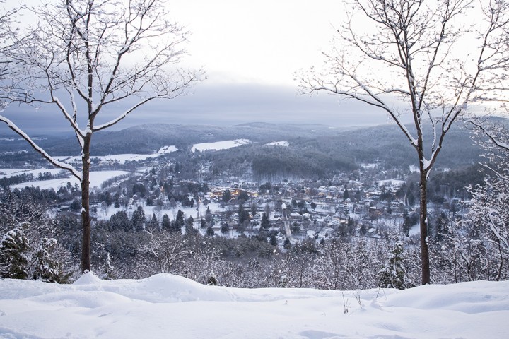 From the summit of Mount Tom, the rural Vermont landscape and twinkling lights of downtown Woodstock can be seen.