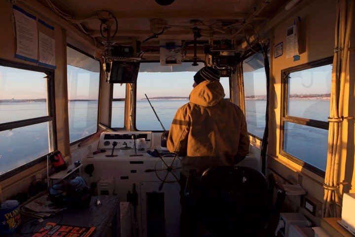 Ethan Rossi, one of the owners of Prudence and Bay Islands Transport, steers the M/V Herbert C. Bonner on its early-morning trip from Bristol to Prudence Island, about two miles away in the heart of Narragansett Bay. Cowie heard stories of how the “temperamental” previous ferry operator would sometimes leave without you if he didn’t get along with you. 