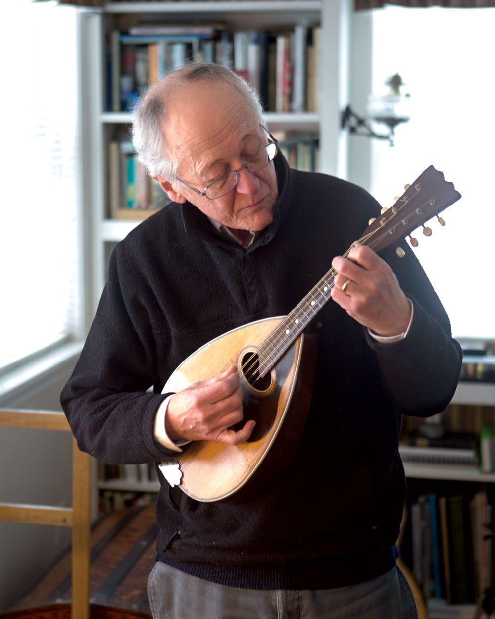 Few people know the island’s history, geography, and stories as well as Joe Bains, pictured here at his home with his mandolin. His grandfather came to Prudence Island in the late 19th century; his parents met on the island and moved here full-time in 1948. “When my father built his house,” said Bains, who was raised and educated on the island, “every bit of siding came from used Navy ammunition boxes, and the posts and beams came from abandoned Navy buildings.” 