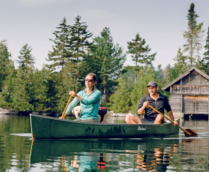 Maya and Brent McCoy, with best buddy Little, paddle the pristine waters of Caspian Lake in Greensboro, Vermont.