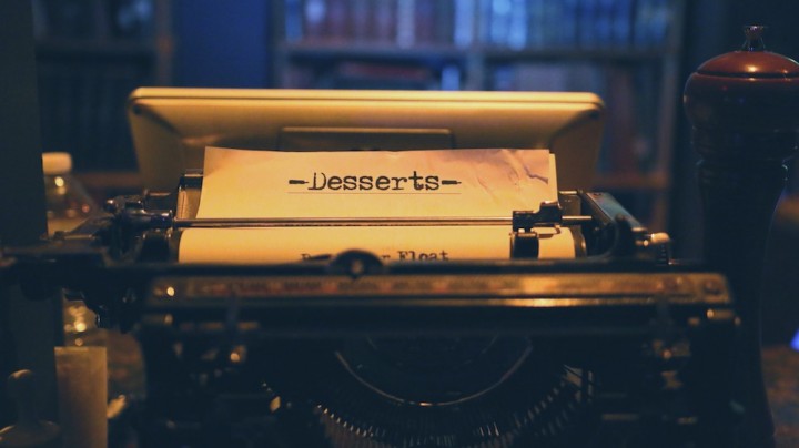 A partial menu sitting in a typewriter. codex nashua speakeasy