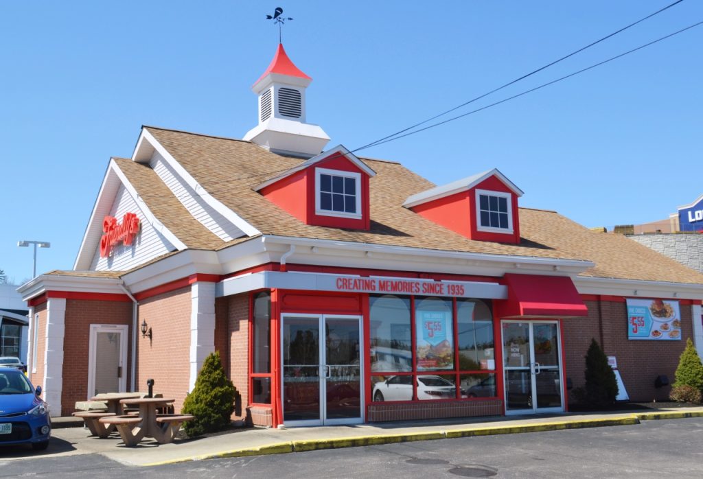 A brick restaurant with red trim, a brown roof, and a sign reading "Creating Memories Since 1935.