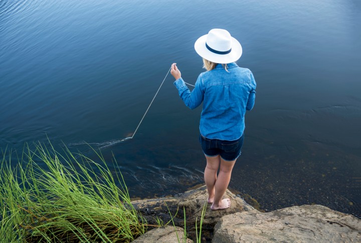 Emily Hanson casts a crabbing line into the salt river. “We were really good at luring them close,” Dom says, “but weren’t fast or skilled enough to get ’em in the net.”