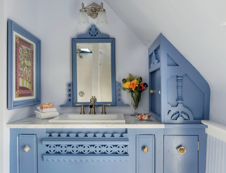 The bathroom vanity was created from a repurposed bureau and painted a rich shade of blue.