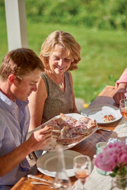 Miles Hooper and Sandy Reese help themselves to grilled salmon. 