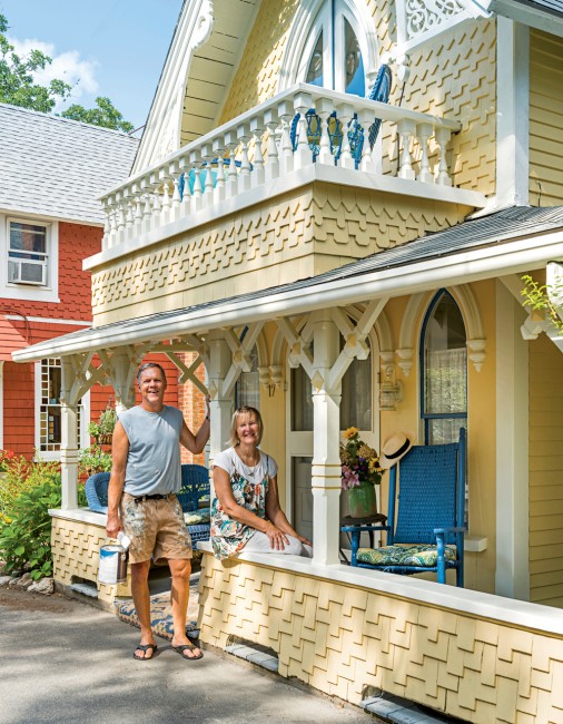 At home in Oak Bluffs’ historic Wesleyan Grove neighborhood, Dick Miller and Kathryn Allen take a break on the porch of “Hunter Cottage,” which they renovated themselves, retaining many of the 1871 home’s original features, furnishings, and artifacts. 