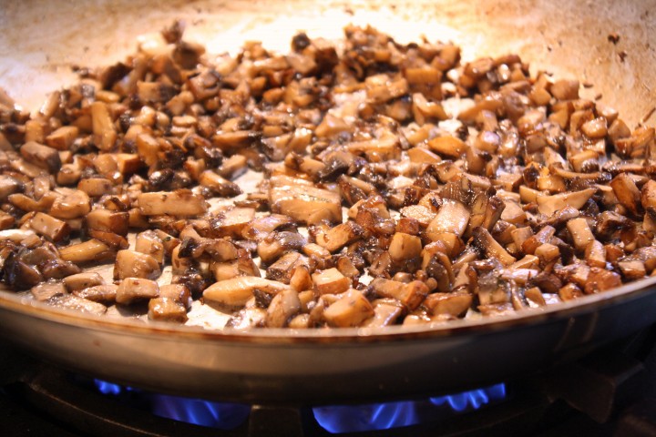 As the mushrooms cook, their edges become brown and crisp.
