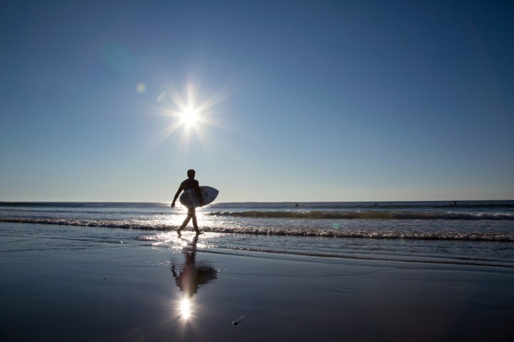 this page: Sunrise at Jenness State Beach in Rye finds a surfer already hitting the waves. 